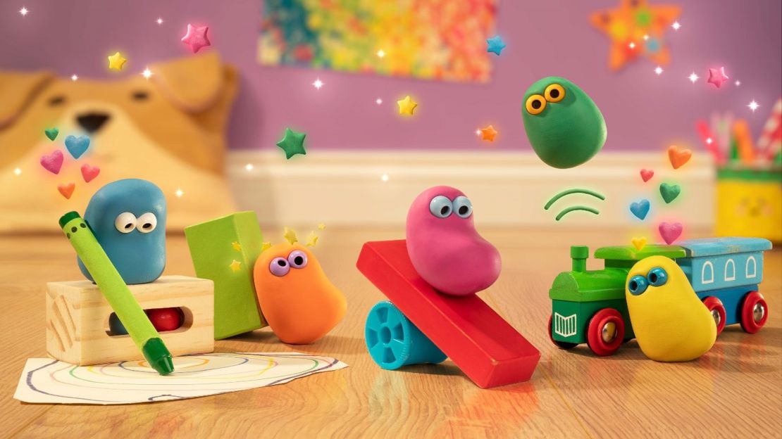 Five colourful animated clay creatures play with toys in a children's nursery