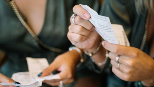 Close up of hands holding receipts