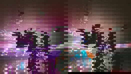 Cameraman holding a camera rig in a skating rink