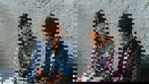 Colleagues in suit reading a paper