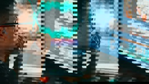 Post-production assistant working on a computer