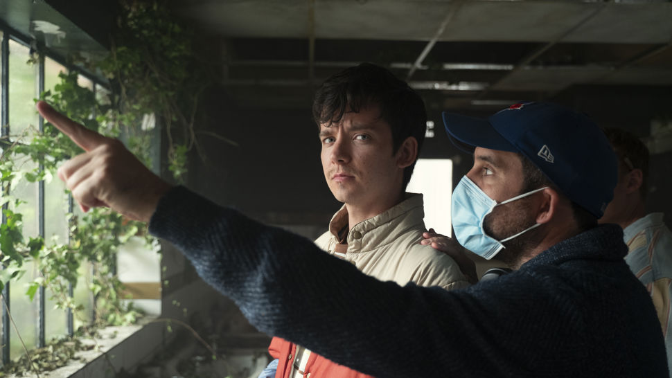 A member of crew gives instruction to Sex education actor.